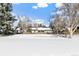 View of the home from across the snowy backyard at 1716 E Mineral Ave, Centennial, CO 80122