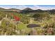 Scenic aerial view of the property with mountain views, a large pond, and lush forest surroundings, perfect for relaxation at 22025 Oehlmann Park Rd, Conifer, CO 80433