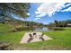 Backyard pond with seating area and fire pit, perfect for outdoor relaxation and entertainment at 22025 Oehlmann Park Rd, Conifer, CO 80433