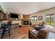 Finished basement with a stone fireplace, bar area, and comfortable leather chairs at 22025 Oehlmann Park Rd, Conifer, CO 80433