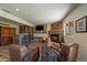 Finished basement with a stone fireplace, bar area, TV, and stylish leather chairs at 22025 Oehlmann Park Rd, Conifer, CO 80433