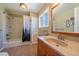 Bright bathroom with a combination shower and tub, a single sink vanity, and a linen closet at 22025 Oehlmann Park Rd, Conifer, CO 80433