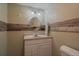 Charming bathroom featuring a circular mirror and rustic wood paneling accent at 22025 Oehlmann Park Rd, Conifer, CO 80433