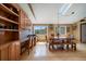 Sunlit dining space with built-in seating, wooden table, and workstation with lots of windows at 22025 Oehlmann Park Rd, Conifer, CO 80433