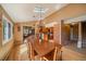 Bright dining area featuring wooden table, chairs and flooring, adjacent to the modern kitchen at 22025 Oehlmann Park Rd, Conifer, CO 80433