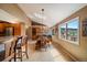 Bright dining area with wood floors, a large window, and a stylish table, perfect for Gathering meals and gatherings at 22025 Oehlmann Park Rd, Conifer, CO 80433