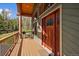 Inviting entrance with a wooden door and deck, ideal for relaxing and enjoying nature's beauty in a serene setting at 22025 Oehlmann Park Rd, Conifer, CO 80433