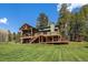 Stunning, multi-level home with a wooden deck, garage, well-maintained lawn, and ample space for outdoor enjoyment at 22025 Oehlmann Park Rd, Conifer, CO 80433