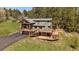 Gorgeous two-story home with extensive deck and log beam architectural features at 22025 Oehlmann Park Rd, Conifer, CO 80433