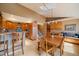 Bright kitchen and dining area with wooden floors, stainless appliances, and a view of the stairs at 22025 Oehlmann Park Rd, Conifer, CO 80433