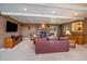 Comfortable living room features a stone fireplace, soft carpet, and ample seating, perfect for entertaining or unwinding at 22025 Oehlmann Park Rd, Conifer, CO 80433