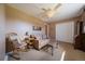 Cozy living room with neutral colors, ceiling fan, ample light, and classic furniture at 22025 Oehlmann Park Rd, Conifer, CO 80433