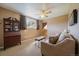 Welcoming living room with comfortable seating, a classic desk, and soft natural light from the window at 22025 Oehlmann Park Rd, Conifer, CO 80433