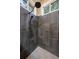 Close-up of a modern shower with dark tile and a unique showerhead, offering a sleek design at 22025 Oehlmann Park Rd, Conifer, CO 80433