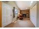 Inviting sitting area featuring a stone fireplace, large windows, and a cozy reading nook at 22025 Oehlmann Park Rd, Conifer, CO 80433