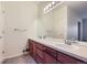 Double vanity bathroom with wood cabinets and neutral colors at 8200 E 8Th Ave # 2102, Denver, CO 80230