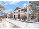 Two-story building exterior with snow-covered landscaping at 8200 E 8Th Ave # 2102, Denver, CO 80230