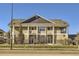 Tan two-story condo building with stone accents and balconies at 8200 E 8Th Ave # 2102, Denver, CO 80230