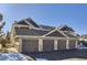 Three-car garage with brown doors and stone accents at 8200 E 8Th Ave # 2102, Denver, CO 80230