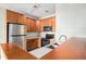 Kitchen with wood cabinets, stainless steel appliances, and a breakfast bar at 8200 E 8Th Ave # 2102, Denver, CO 80230