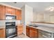 Kitchen boasts wood cabinets, stainless steel appliances, and double sink at 8200 E 8Th Ave # 2102, Denver, CO 80230