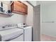 Bright laundry room with washer, dryer, and storage cabinets at 8200 E 8Th Ave # 2102, Denver, CO 80230