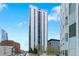 Contemporary high-rise residence offering a serene outdoor seating area with mature trees and expansive city views at 1625 Larimer St # 1806, Denver, CO 80202