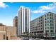 A modern condominium high-rise in an urban setting, adjacent to commercial structures and city street at 1625 Larimer St # 1806, Denver, CO 80202