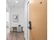 Inviting hallway featuring wood-look floors, a charming bench, and stylish decor at 1625 Larimer St # 1806, Denver, CO 80202