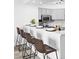 Modern kitchen with white countertops, bar seating, and contemporary appliances at 1625 Larimer St # 1806, Denver, CO 80202