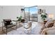 Inviting living room featuring comfortable seating, stylish decor, and a large window with urban views at 1625 Larimer St # 1806, Denver, CO 80202