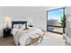 Comfortable bedroom with city view and large window at 1625 Larimer St # 1806, Denver, CO 80202