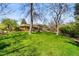 Large backyard with mature trees, a patio, and a custom water feature at 5020 W Quarles Dr, Littleton, CO 80128