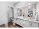 Updated bathroom featuring double vanity sinks, modern fixtures and neutral tile at 5020 W Quarles Dr, Littleton, CO 80128