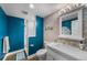 Contemporary bathroom featuring a glass enclosed shower, a modern vanity, and stylish blue walls at 5020 W Quarles Dr, Littleton, CO 80128