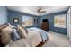Blue-walled bedroom with ceiling fan and two windows providing great natural light at 5020 W Quarles Dr, Littleton, CO 80128