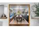Elegant dining room with a large wooden table, modern light fixture, and stylish decor at 5020 W Quarles Dr, Littleton, CO 80128