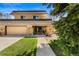 Charming home featuring a well-manicured front lawn, a two-car garage, and stone accents at 5020 W Quarles Dr, Littleton, CO 80128