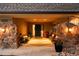 Inviting covered front porch with stone pillars, potted flowers, and seating area at 5020 W Quarles Dr, Littleton, CO 80128