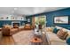 Cozy Gathering room with a fireplace, comfortable seating, and sliding glass doors to the patio at 5020 W Quarles Dr, Littleton, CO 80128