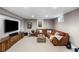 Cozy finished basement with a comfortable seating area and entertainment center at 5020 W Quarles Dr, Littleton, CO 80128