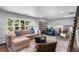 Spacious living room with large windows, comfortable seating, and stylish decor at 5020 W Quarles Dr, Littleton, CO 80128