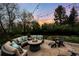 Outdoor patio with a fire pit, comfortable seating, and ambient string lighting at 5020 W Quarles Dr, Littleton, CO 80128