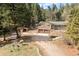 Well-maintained home with a two-car garage, complemented by a storage shed and wooded surroundings at 993 Fall River Rd, Idaho Springs, CO 80452