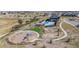 Aerial view of a community park with a playground, pool, covered ramada, and lounge chairs at 3898 Descent St, Castle Rock, CO 80108