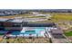 Aerial view of a resort-style swimming pool, lounge chairs and a pool house in an upscale community at 3898 Descent St, Castle Rock, CO 80108