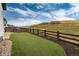 Backyard featuring a fenced in yard, green turf, gravel and wood chip landscaping at 3898 Descent St, Castle Rock, CO 80108