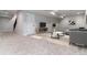 Finished basement with gray carpet, light gray walls, TV, modern furniture, and stairs to the main level at 3898 Descent St, Castle Rock, CO 80108