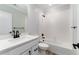 Clean white bathroom with black fixtures, a tiled shower over tub, and a quartz countertop vanity at 3898 Descent St, Castle Rock, CO 80108