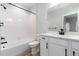 Bathroom with a shower/tub combo and white shaker cabinets at 3898 Descent St, Castle Rock, CO 80108
